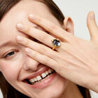 Ring with oval faceted black crystal