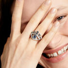 Eye-shaped ring with faceted blue crystal