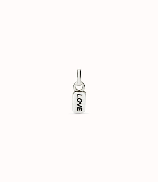 Sterling silver-plated charm with the word “love”.
