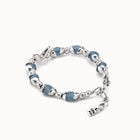Beaded bracelet with blue crystals and a central butterfly