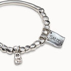 Beaded stretch bracelet with tubular piece and charms