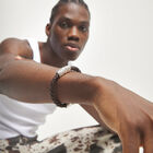Brown braided leather bracelet with a metal detail