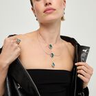 Double necklace with three drop-shaped pendants featuring green faceted crystals