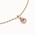Charm with a pink crystal