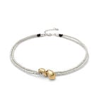 Multi-strand necklace with two intertwined drops