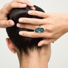 Drop-shaped ring with a green faceted crystal