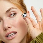 Ring with oval faceted black crystal