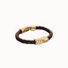 Brown braided leather bracelet with a metal detail