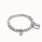 Beaded stretch bracelet with tubular piece and a charm