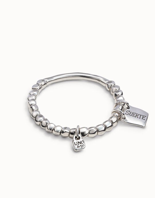 Beaded stretch bracelet with tubular piece and a charm