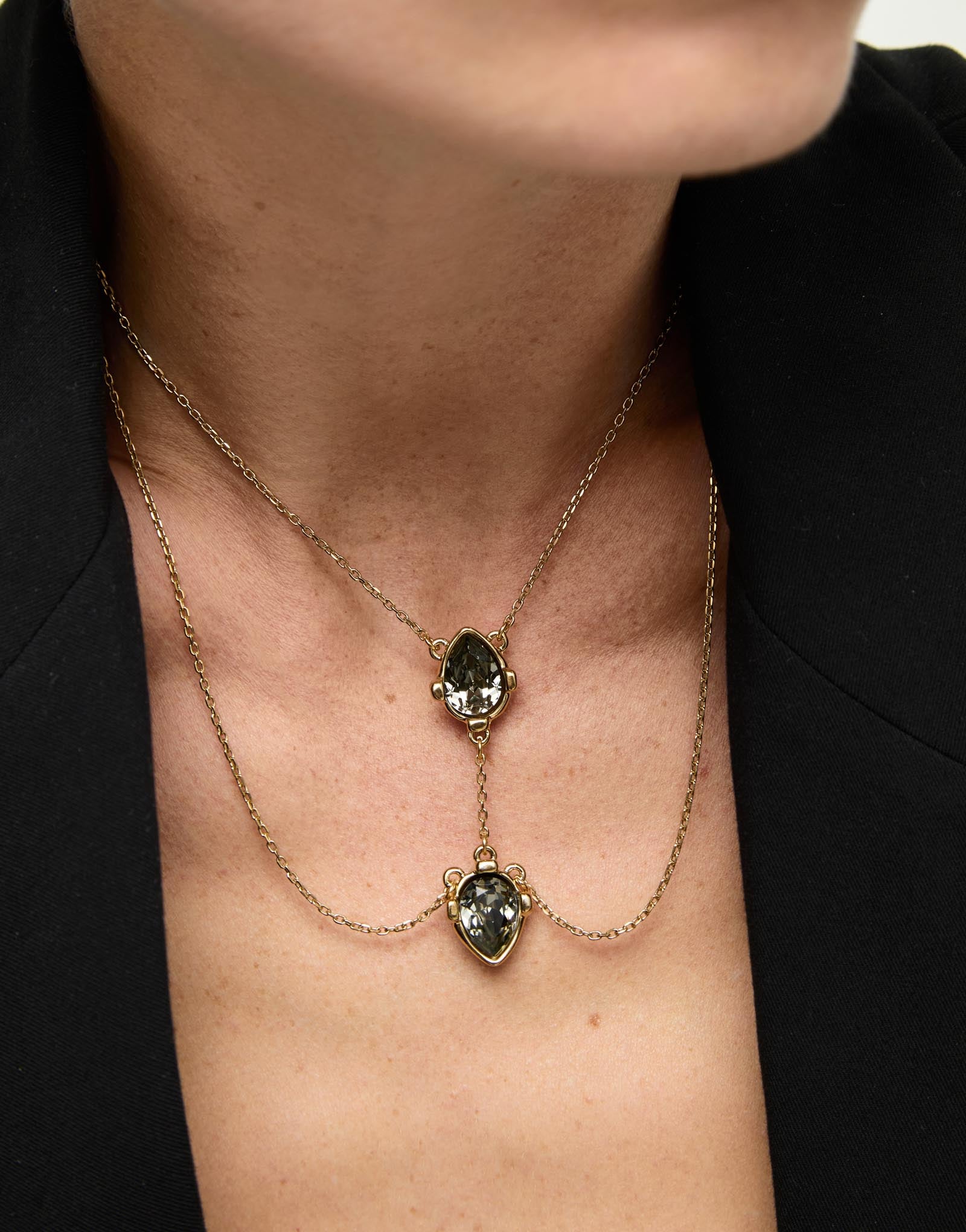 Double necklace with two drop-shaped pendants featuring grey faceted crystals