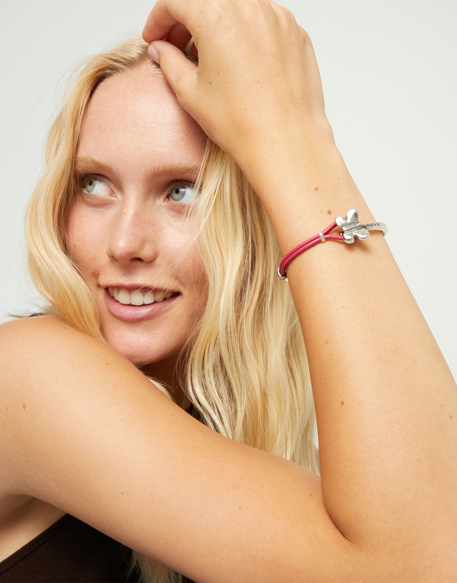Pink leather bracelet with butterfly ornament