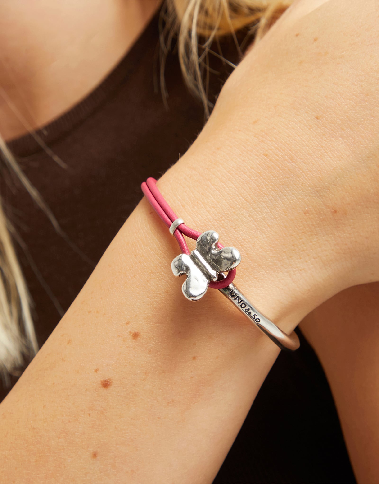 Pink leather bracelet with butterfly ornament