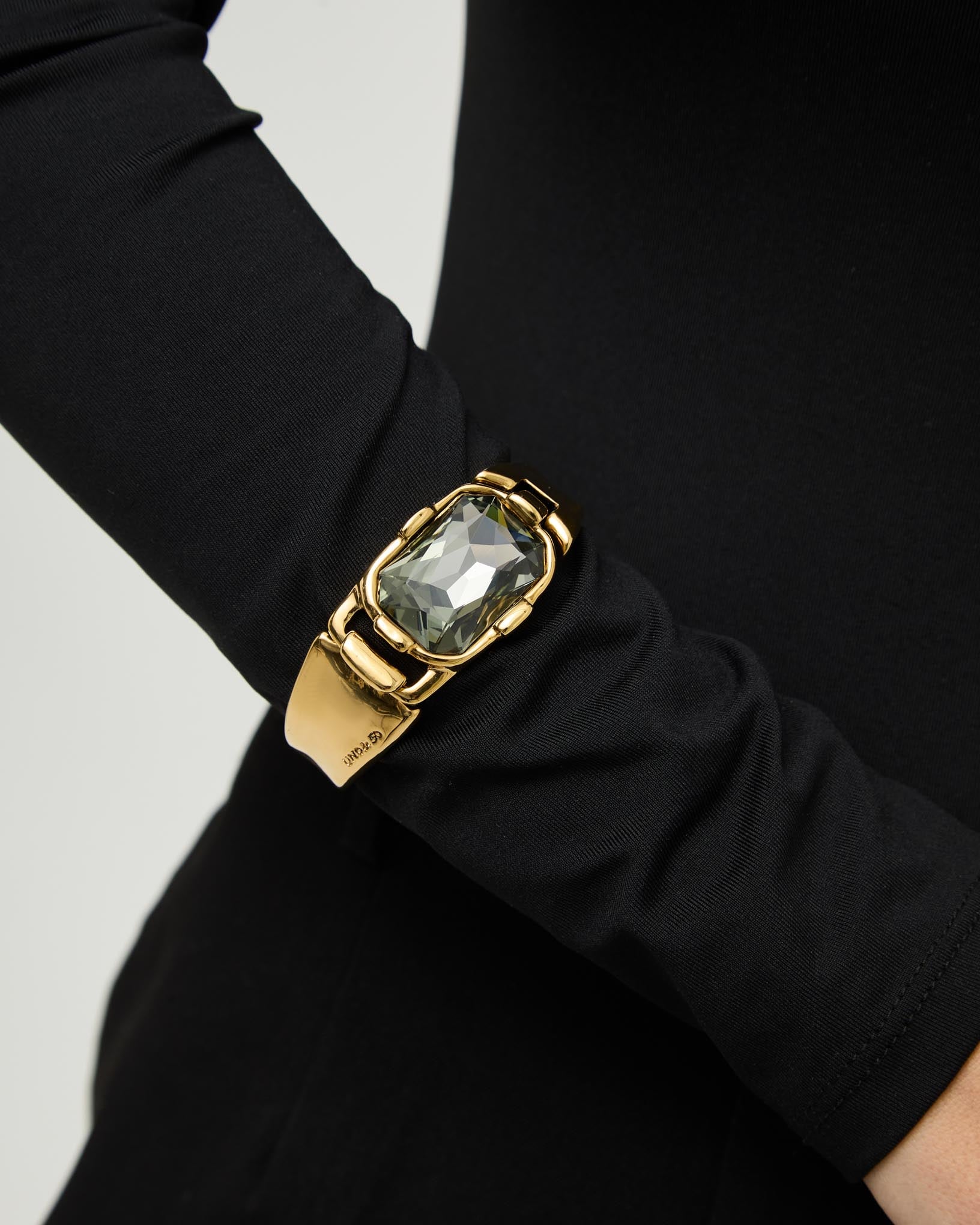 Rigid bracelet with a rectangular grey faceted crystal