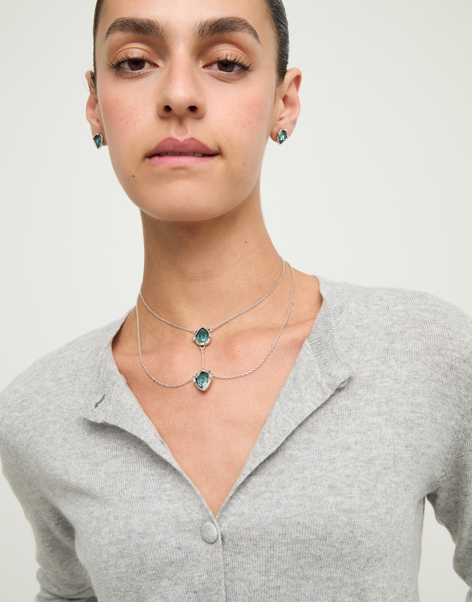 Double necklace with two drop-shaped pendants featuring blue faceted crystals