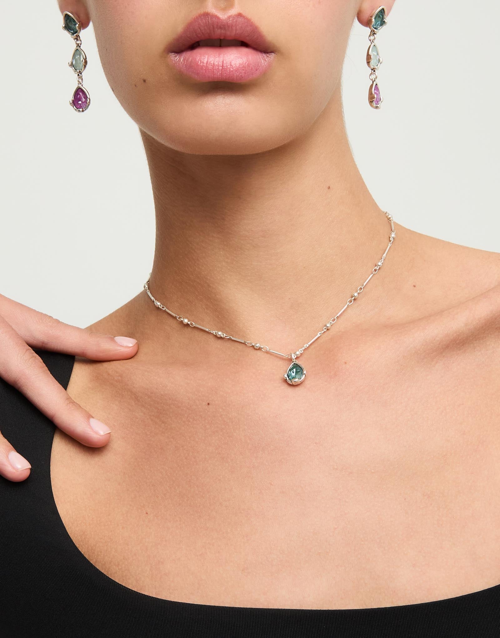 Necklace with a green drop-shaped faceted crystal