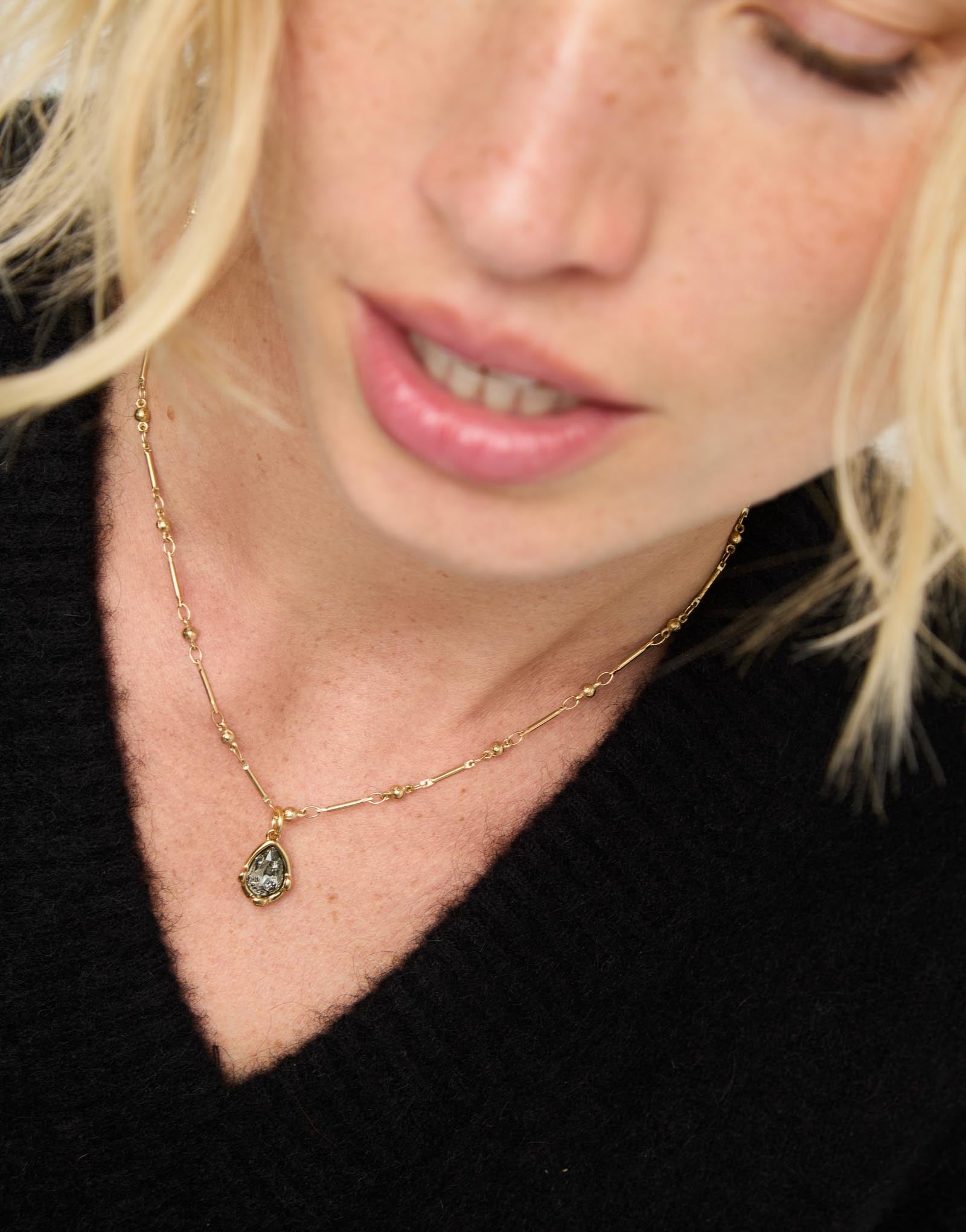 Necklace with a grey drop-shaped faceted crystal